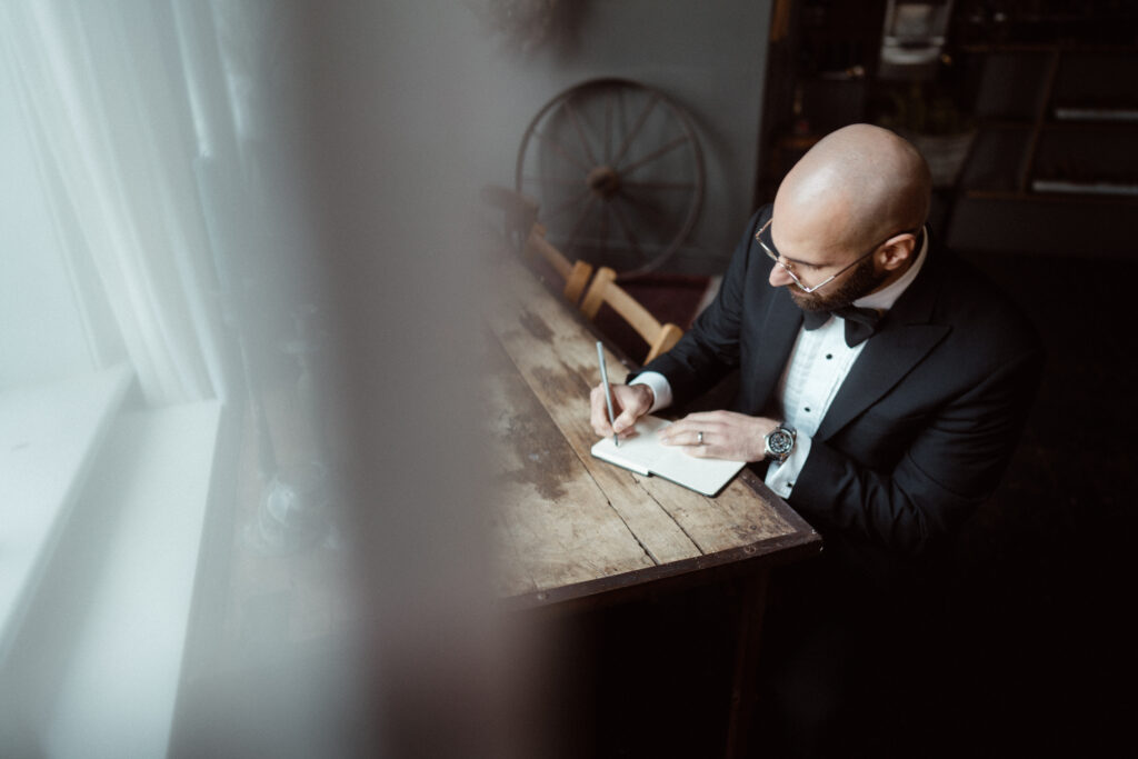 Groom writing his vows.
