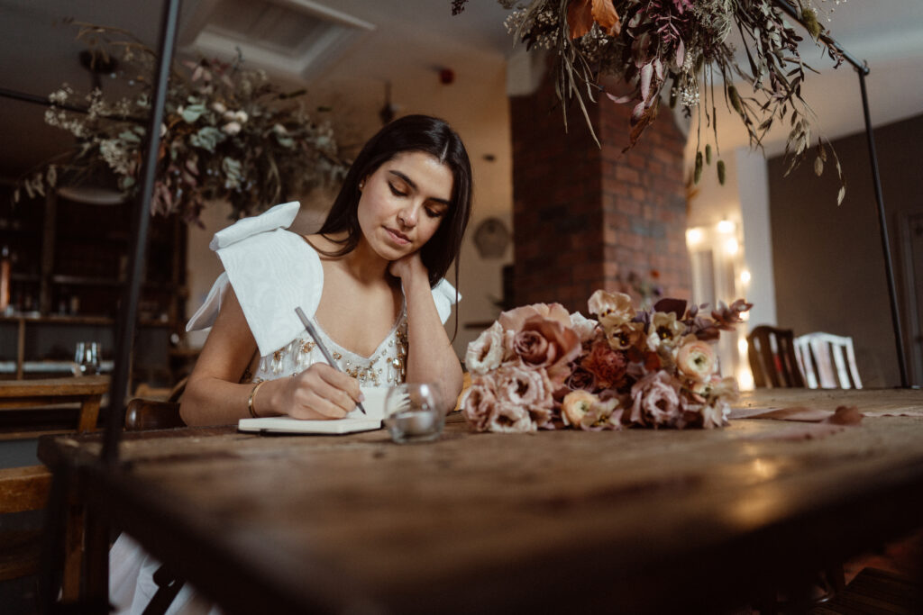 Bride writing her vows.